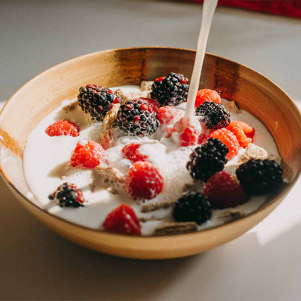 milk being poured on cereal